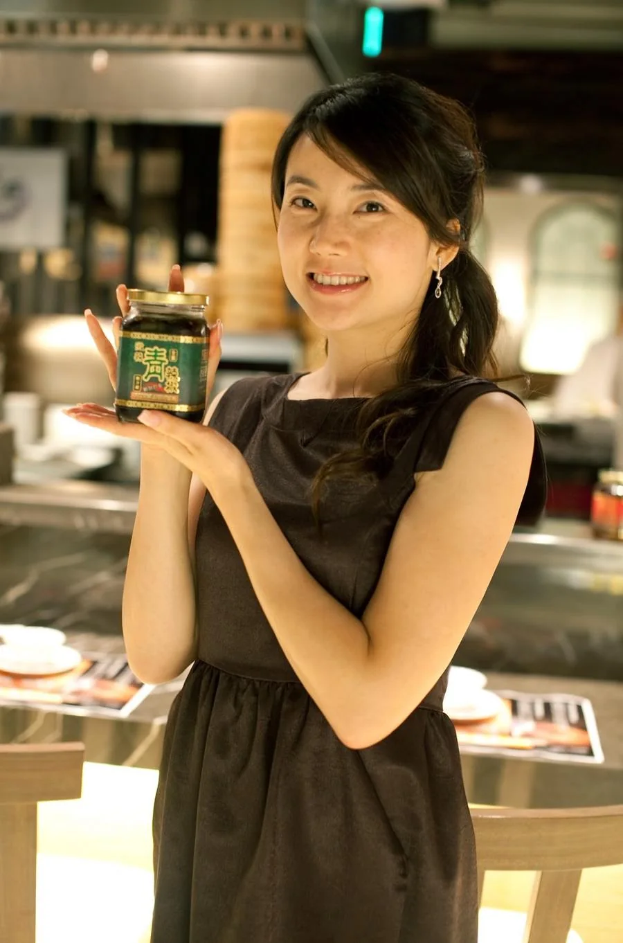 Founder holding the sauce jar